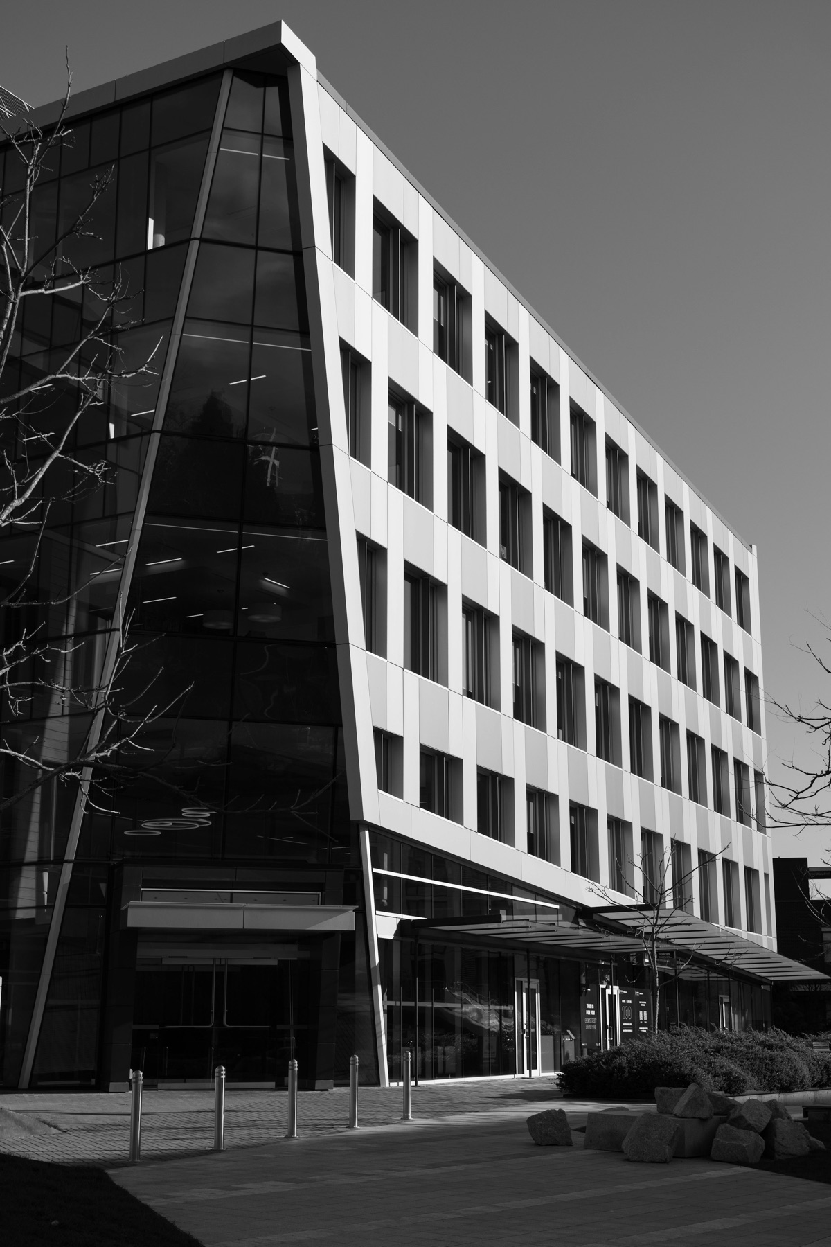 Angular black-and-white view of a modern multi-story commercial office building